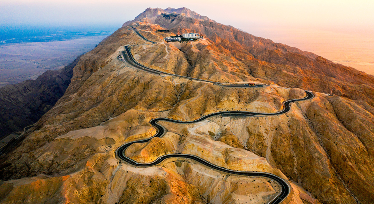 A panoramic view of the winding roads of the Jebel Hafit mountains as the sun rises_.jpg